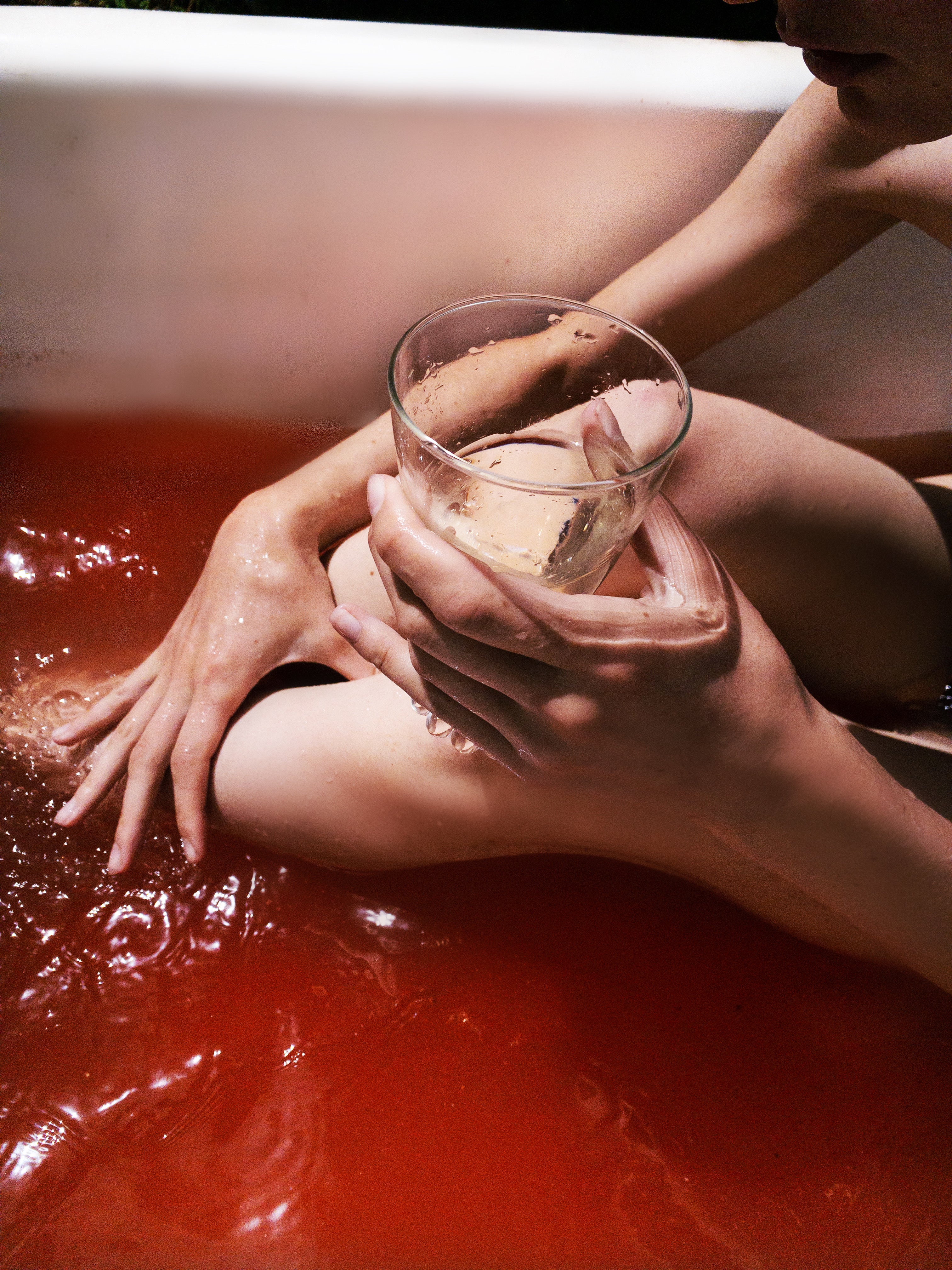 A person enjoying self care in Heathen's coral herbal bath soak. 