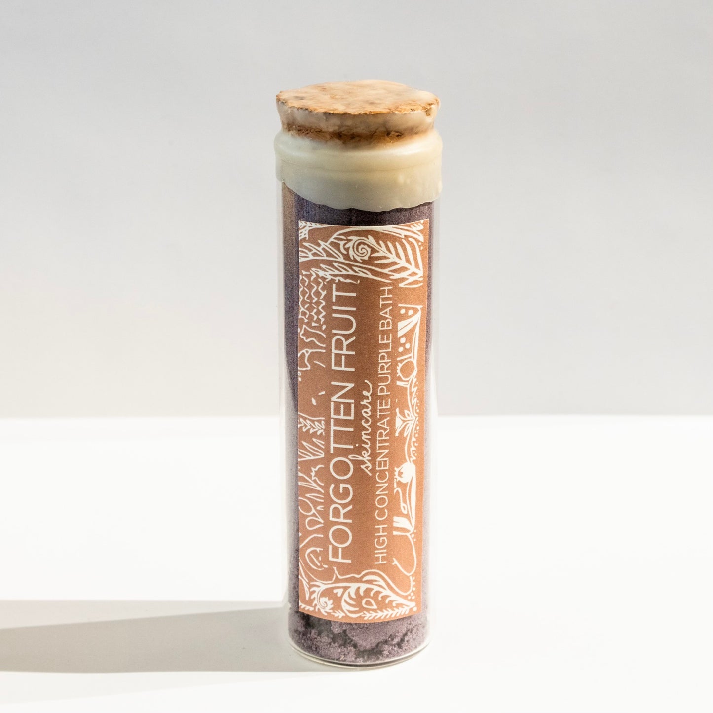 Forgotten Fruit's High Concentrate Purple Bath in a glass vial with wax seal.