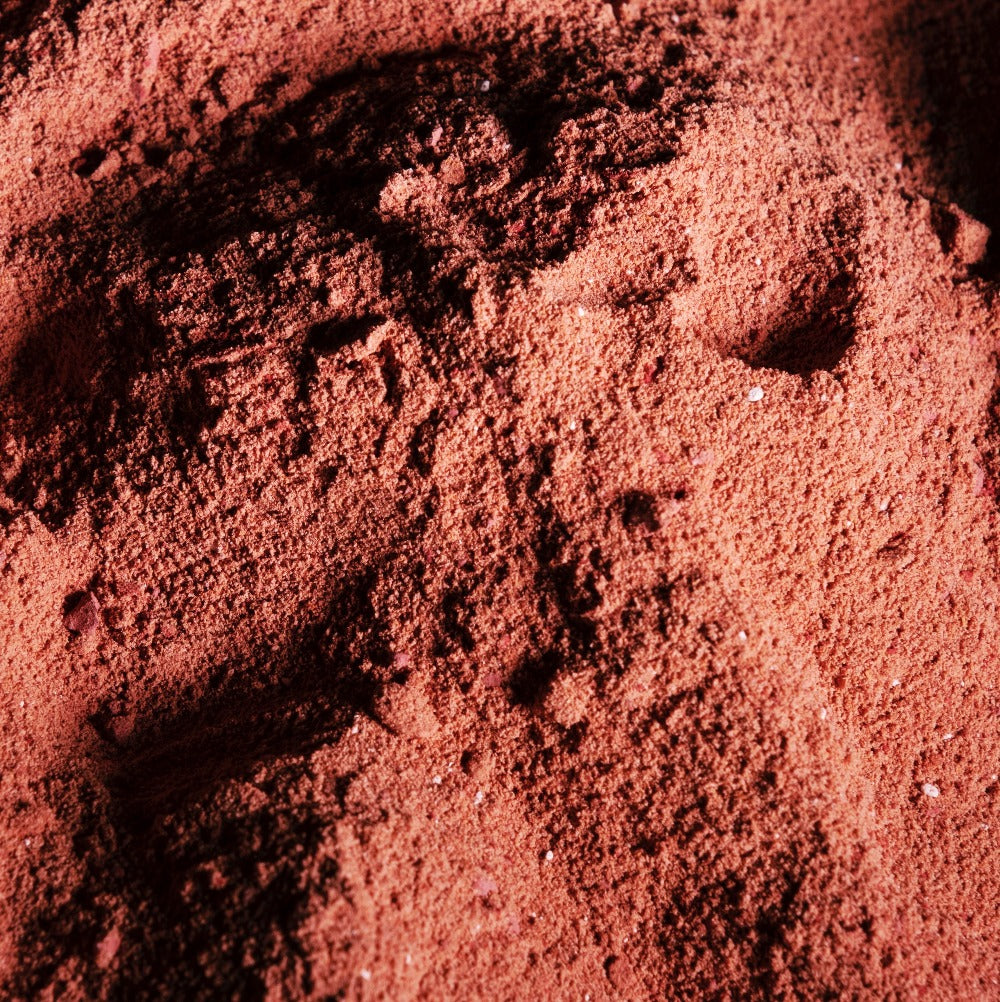 Image of pink herbal bath soak in powder form before adding to the bath. 