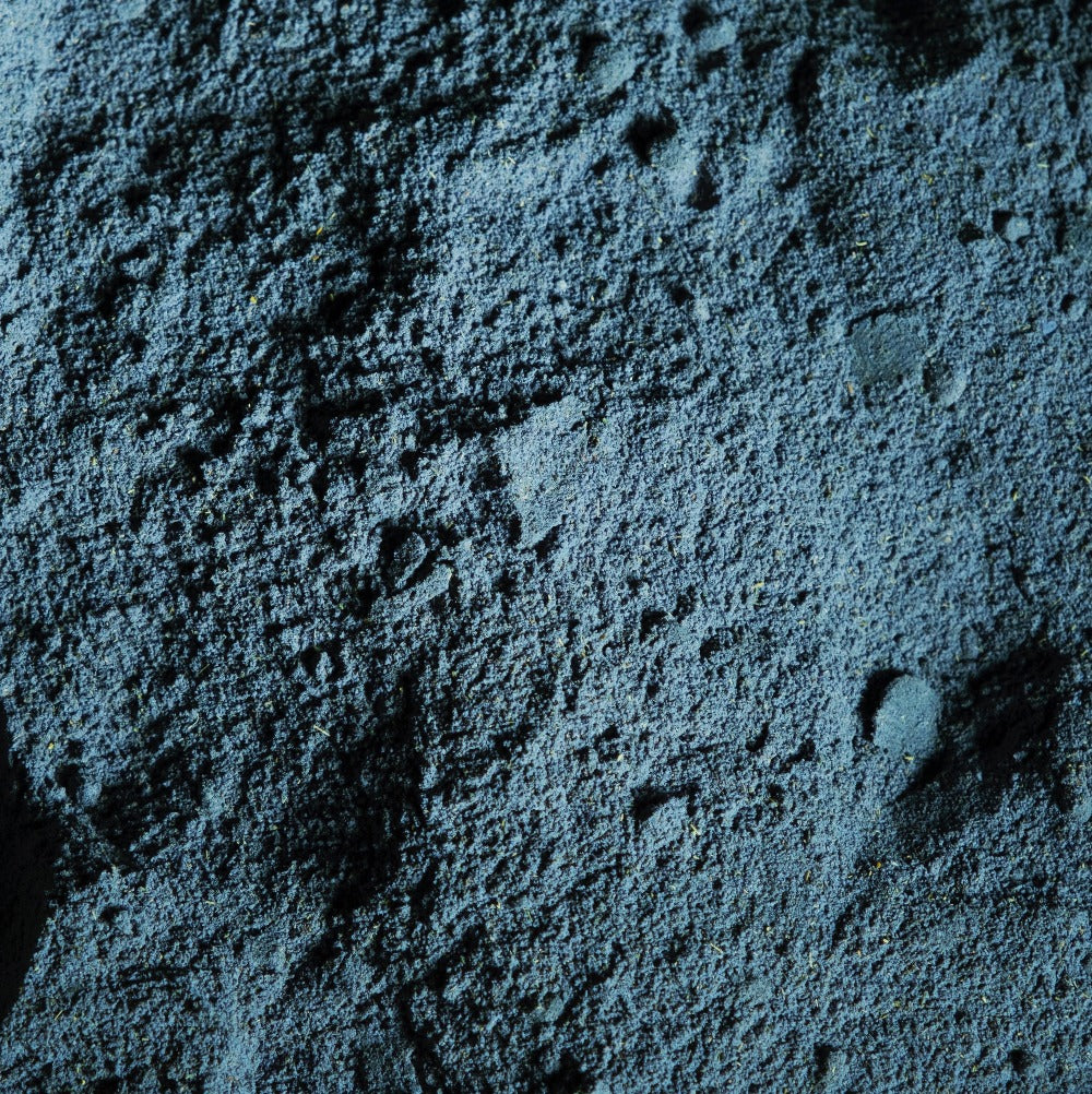 Image of blue bath soak in powder form before adding to the bath. 